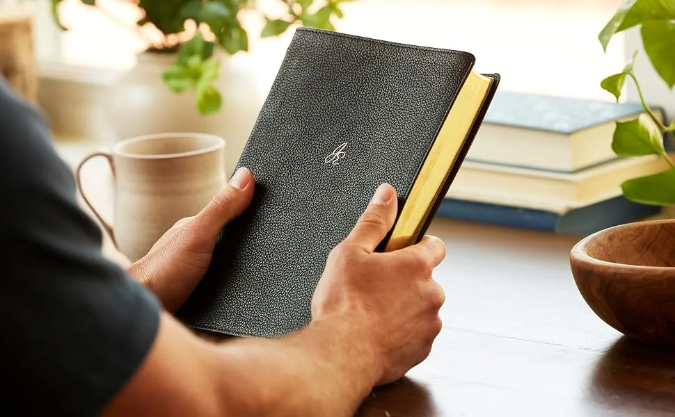 Jonathan Edwards NKJV Study Bible leather edition being held at a desk