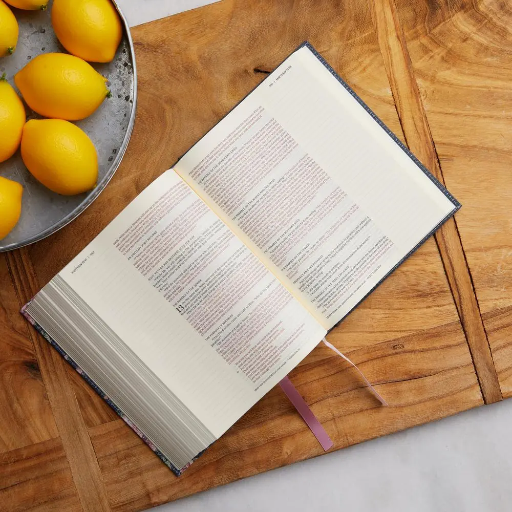Journal the Word Bible NKJV resting on a wooden table, illustrating journaling and devotional Scripture reading.