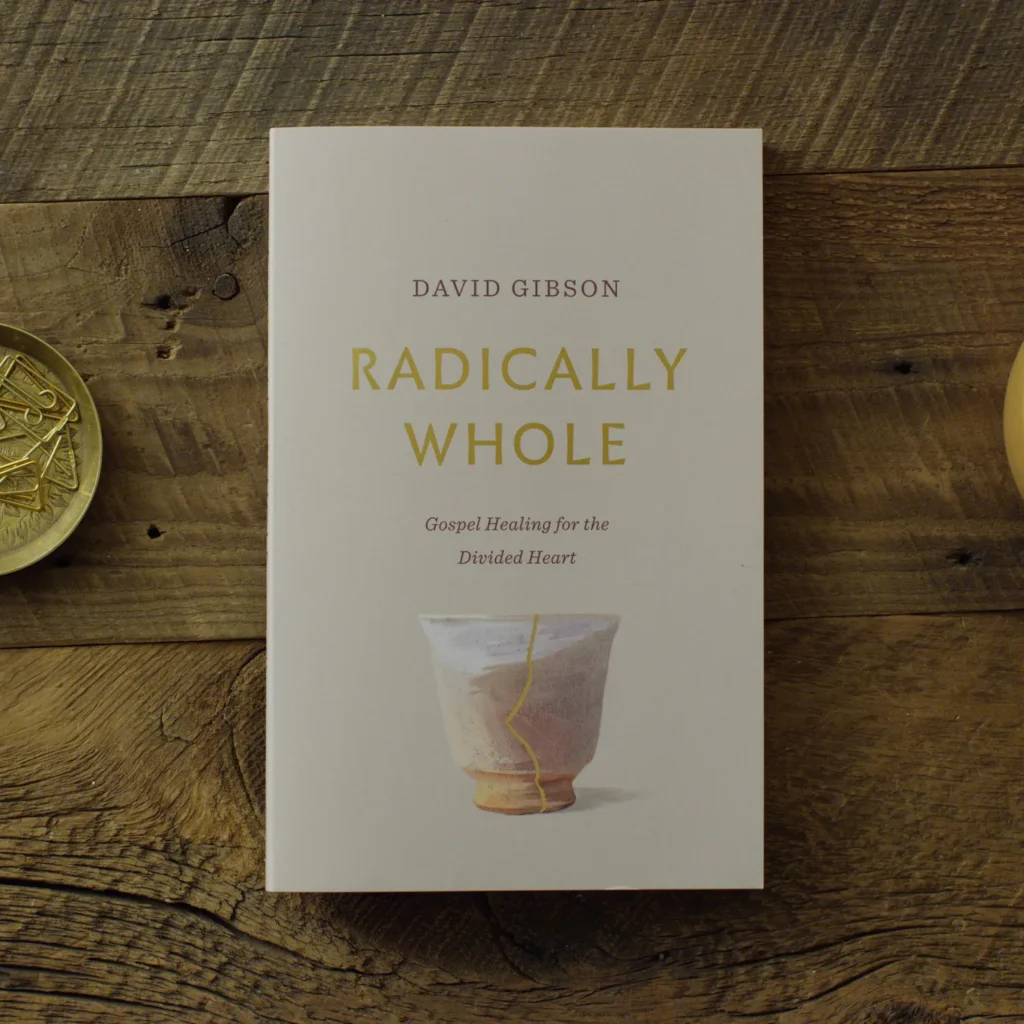 Radically Whole by David Gibson on a wooden table, with a gold-repaired pottery vessel pictured on the cover.