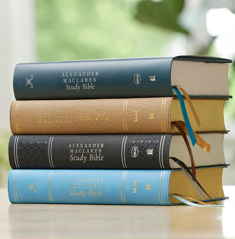 Maclaren Study Bible stacked on a table in leathersoft and hardcover formats