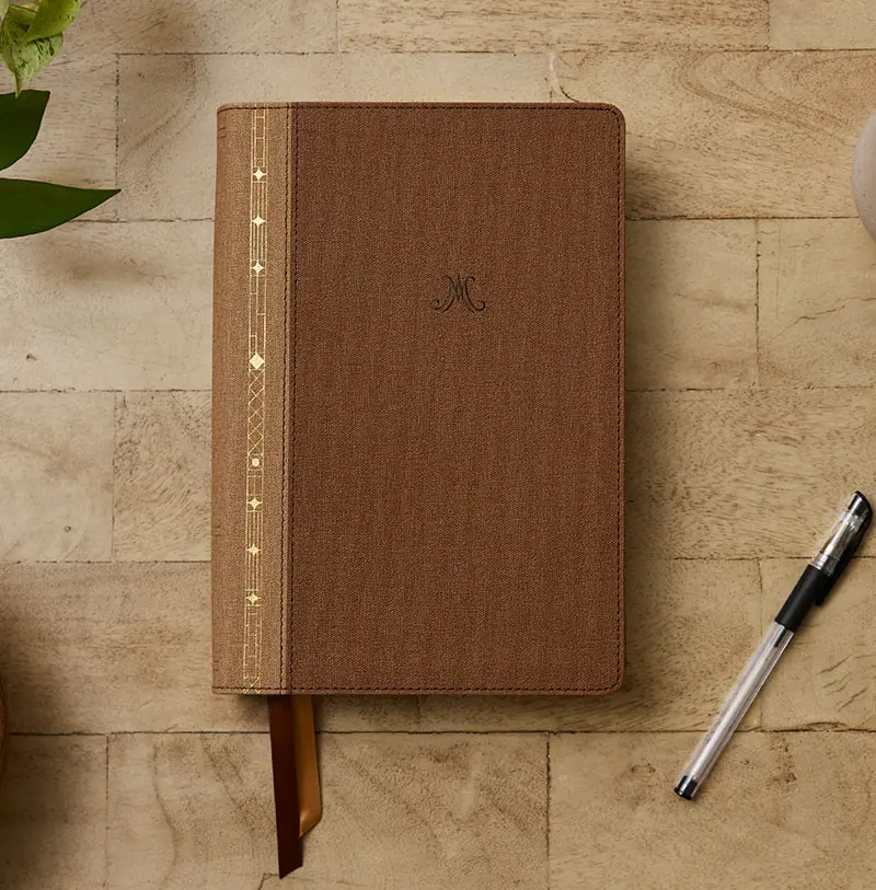 Alexander Maclaren Study Bible brown leathersoft edition resting on a wooden table