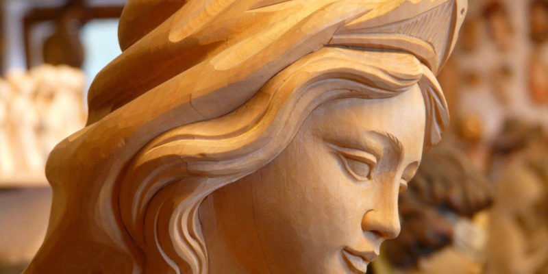 wooden statue of female representing faithful christian women