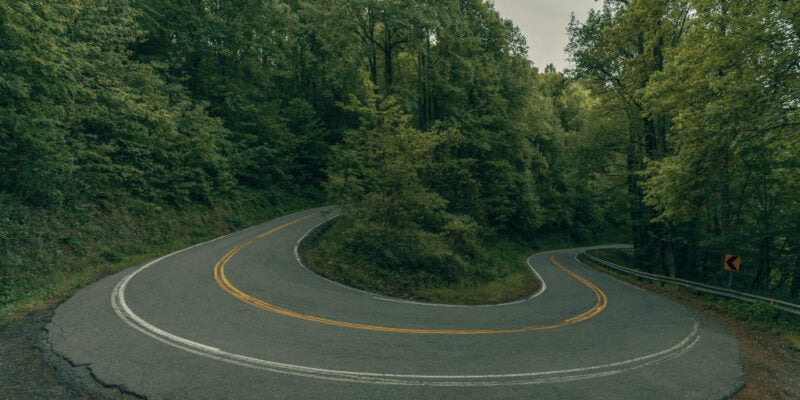 image of hairpin turn on mountain road illustrating speaking truth and navigating change