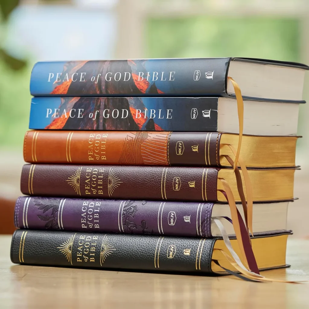Stack of Peace of God Bible NKJV editions in various bindings and colors, highlighting available formats and premium craftsmanship.